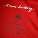 Close-up of Nottingham Forest 2025/26 Home Fan Version jersey label with "A new history..." text.