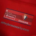 Close-up of Osasuna 2025/26 home fan jersey label showing Macron logo and club crest.