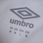 Close-up of the Umbro logo and size details on the Rayo Vallecano 2025/26 Home Fan Version jersey fabric.