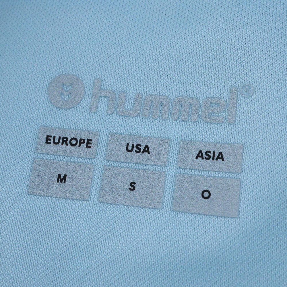 Close-up of Real Betis Away 2025/26 Fan Version shirt label showing Hummel logo and size information.