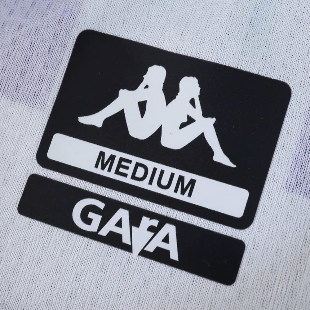 Close-up of the Kappa logo, size label "Medium," and GARA text on Real Valladolid 2025/26 Home Fan jersey.