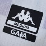 Close-up of the Kappa logo, size label "Medium," and GARA text on Real Valladolid 2025/26 Home Fan jersey.