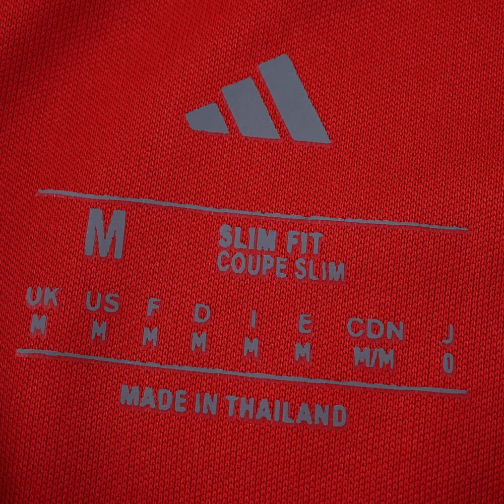 Close-up of the Sevilla FC Away 2025/26 Fan Version shirt label showing size, fit, and "Made in Thailand" text.