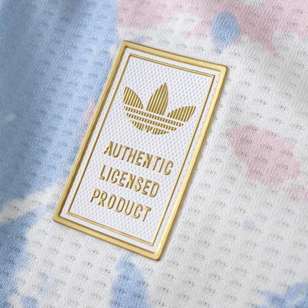 Close-up of the Aston Villa 2025/26 Third jersey badge reading "Authentic Licensed Product" with Adidas logo.