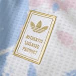 Close-up of the Aston Villa 2025/26 Third jersey badge reading "Authentic Licensed Product" with Adidas logo.