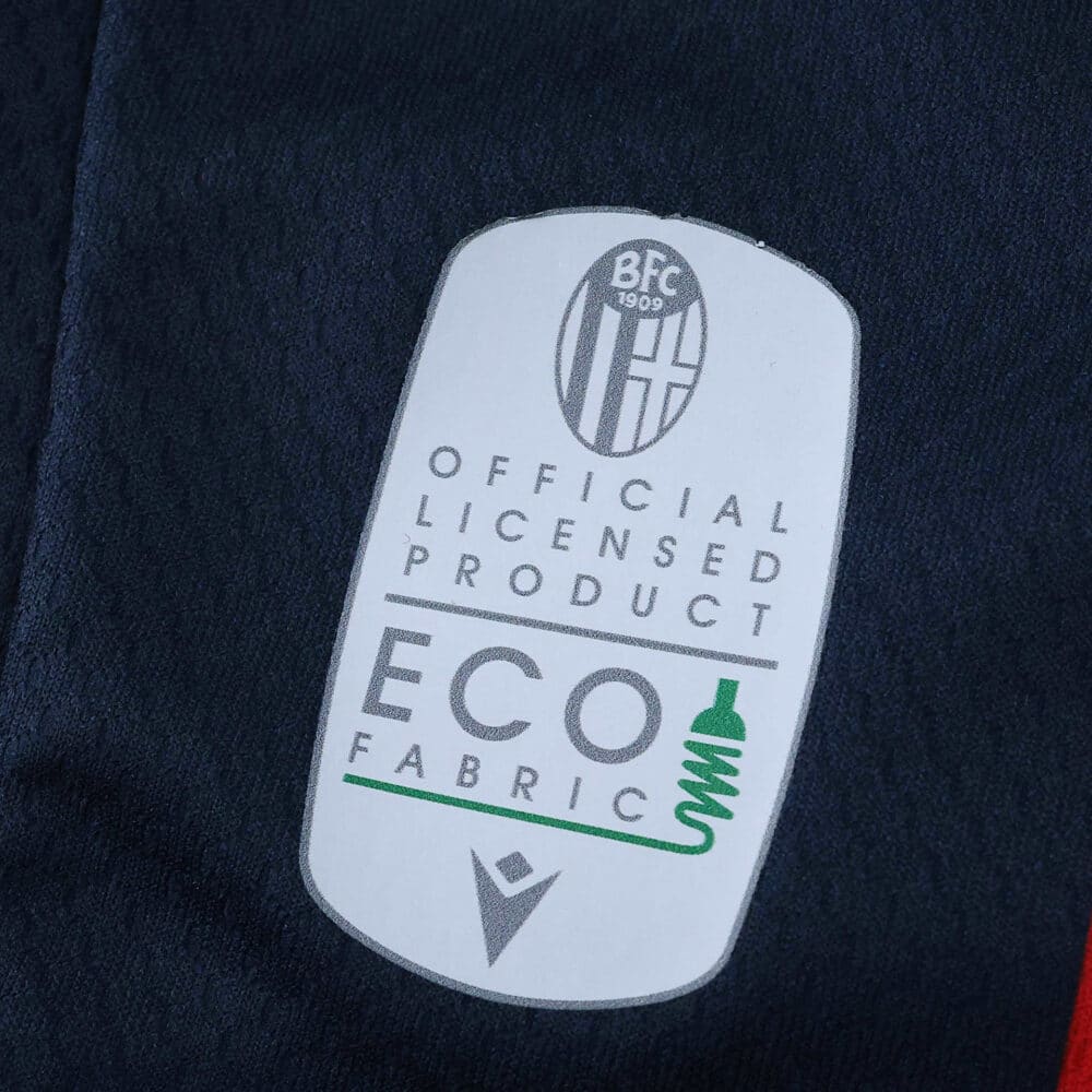 Close-up of Bologna FC 2025/26 fan version jersey featuring official licensed product and eco fabric label.