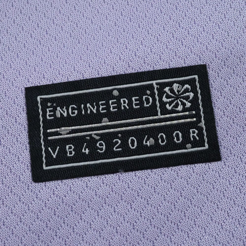 Close-up of the "Engineered" label on the Brighton & Hove Albion 2025/26 away fan jersey.