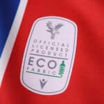 Crystal Palace 2025/26 home kit fan version badge with eco fabric label on red and blue material.