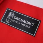 Close-up of the Granada CF 2025/26 Fan Version jersey label reading "Granada CF Official Product".