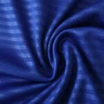 Close-up of blue Leeds United Away 2025/26 Fan Version fabric showing texture and subtle stripe pattern.