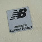 Close-up of "Authentic Licensed Product" New Balance patch on Lille LOSC Away 2025/26 Fan Version jersey.