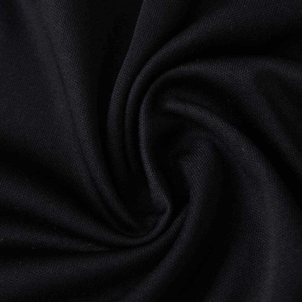 Close-up of black Sevilla FC Third 2025/26 Fan Version jersey fabric with visible texture.