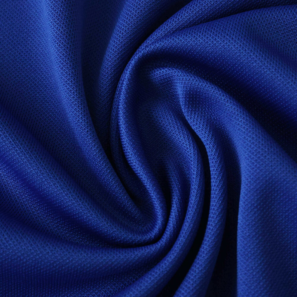 Close-up of blue AS Monaco Away 2025/26 Fan Version jersey fabric with a swirling texture pattern.