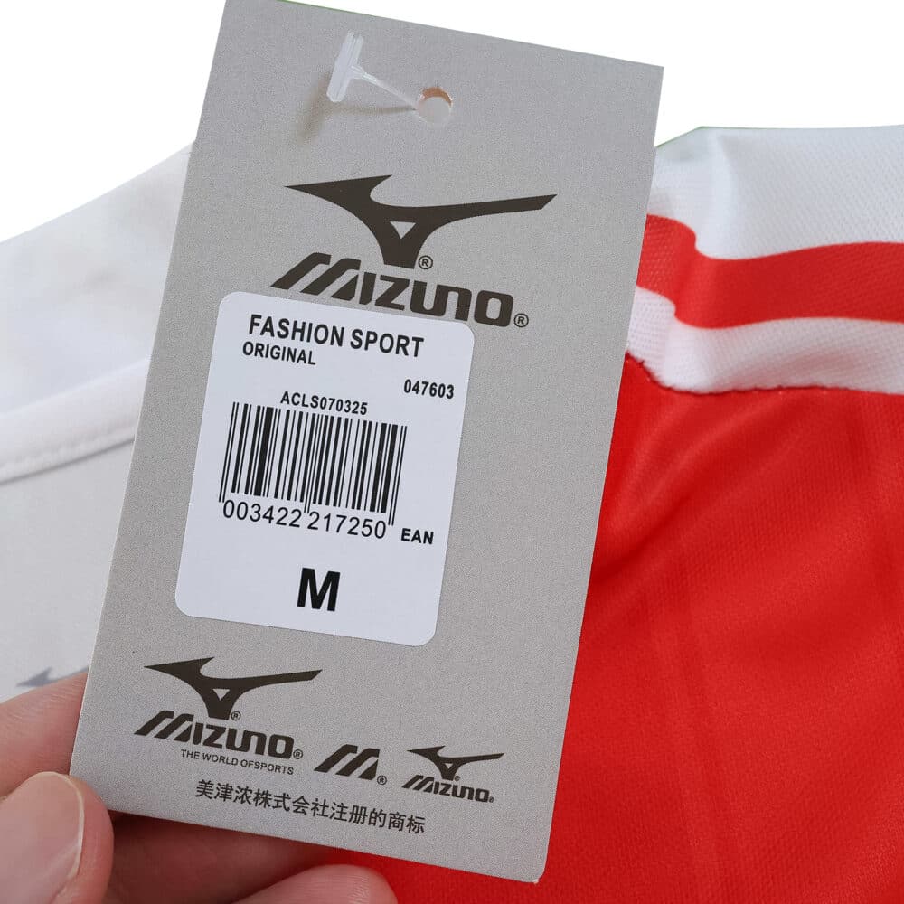 Close-up of the AS Monaco 2025/26 Home Fan jersey tag showing Mizuno branding and medium size label.