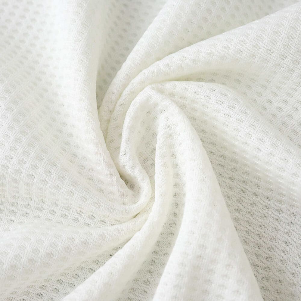 Close-up of Aston Villa Third 2025/26 Player Version jersey fabric showing white textured material.