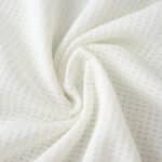 Close-up of Aston Villa Third 2025/26 Player Version jersey fabric showing white textured material.