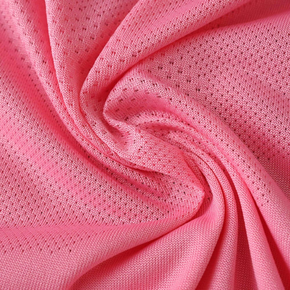 Close-up of the pink fabric used in the Celta Vigo Third 2025/26 Fan Version jersey, showing its breathable texture.