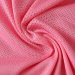 Close-up of the pink fabric used in the Celta Vigo Third 2025/26 Fan Version jersey, showing its breathable texture.