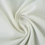 Close-up of the Celtic Third 2025/26 Player Version jersey fabric, showing its light color and breathable texture.