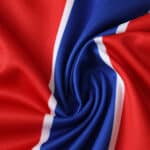 Close-up of Crystal Palace 2025/26 home fan version jersey fabric showing red, blue, and white stripes.