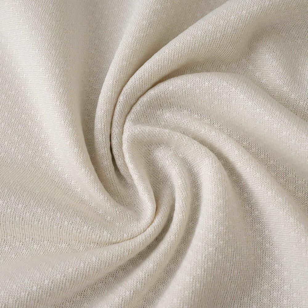 Close-up of the FC Porto Third 2025/26 Fan Version jersey fabric in an off-white color, showing texture.