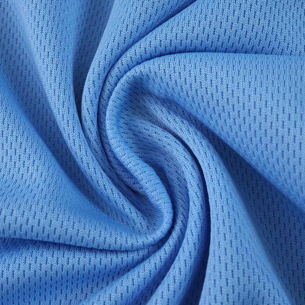 Close-up of Lazio Home 2025/26 Fan Version jersey fabric in light blue, showing texture and weave pattern.