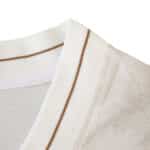 Close-up of the Napoli Away 2025/26 Fan Version collar with gold accent on white fabric.
