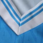 Close-up of the Napoli Home 2025/26 fan jersey collar with white and blue striped trim.