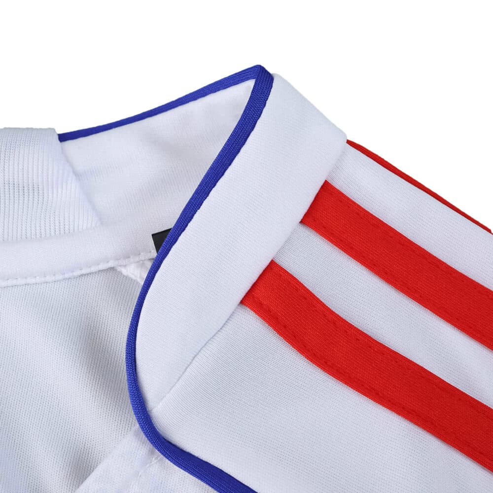 Close-up of Olympique Lyonnais 2025/26 home fan jersey collar with red stripes and blue trim.