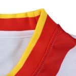 Close-up of Rayo Vallecano 2025/26 home fan jersey collar with red and yellow trim on white fabric.