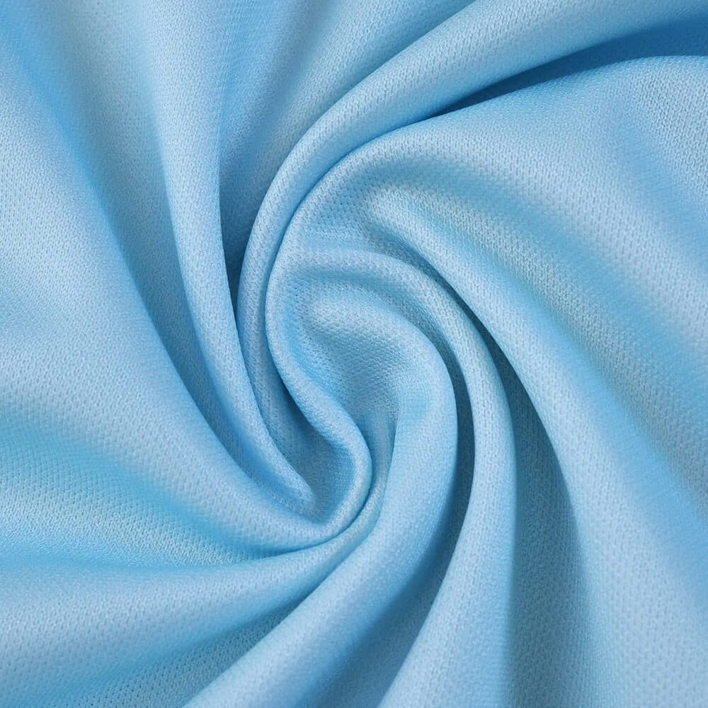 Close-up of light blue fabric used in the Real Betis Away 2025/26 Fan Version jersey.