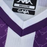 Close-up of the Real Valladolid 2025/26 home fan jersey collar with purple and white stripes.
