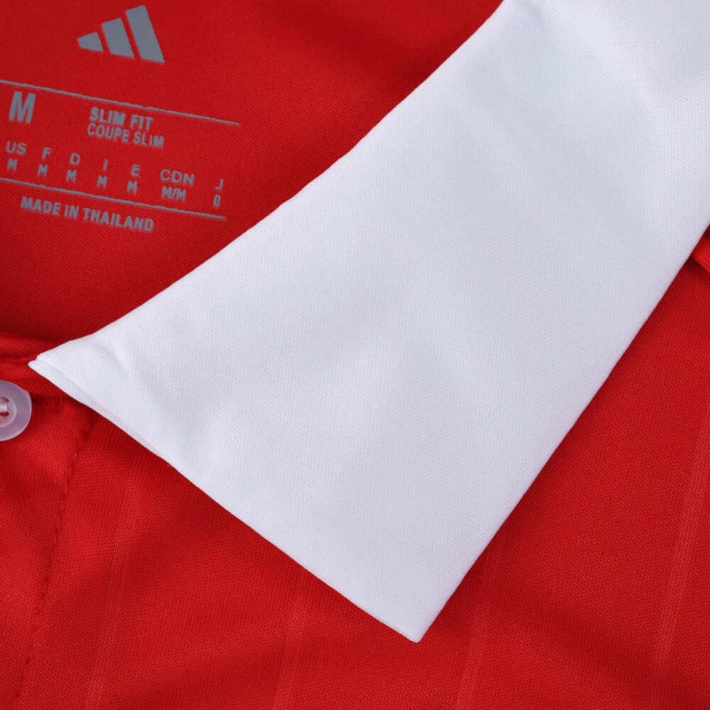 Close-up of the Sevilla FC Away 2025/26 Fan Version collar showing red fabric and white trim.