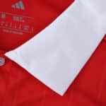 Close-up of the Sevilla FC Away 2025/26 Fan Version collar showing red fabric and white trim.