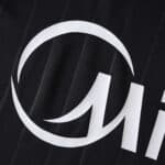 Close-up of the Sevilla FC 2025/26 third fan version jersey featuring a white sponsor logo on black fabric.