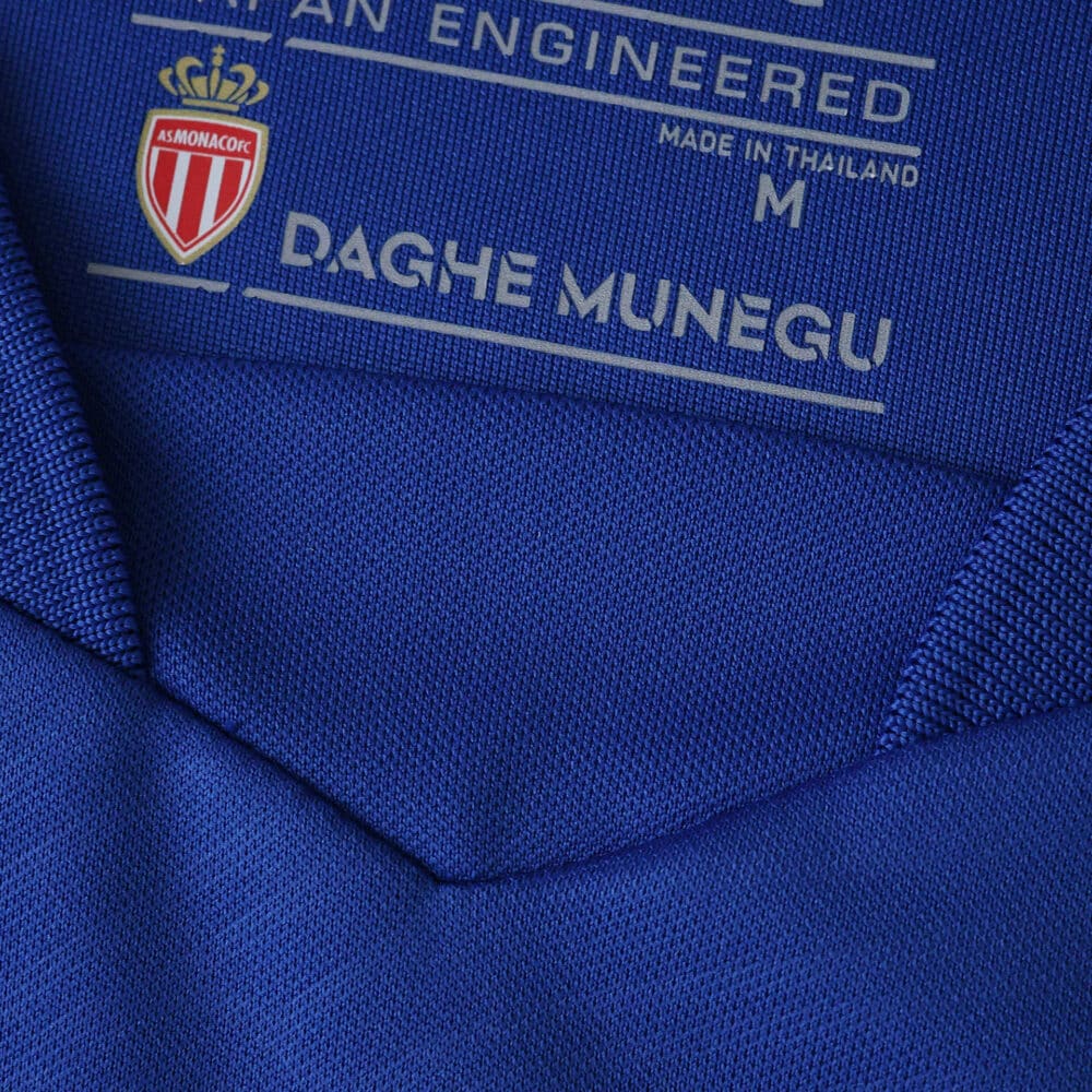 Close-up of the collar interior on the AS Monaco Away 2025/26 Fan Version jersey, showing club logo and label details.