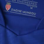 Close-up of the collar interior on the AS Monaco Away 2025/26 Fan Version jersey, showing club logo and label details.
