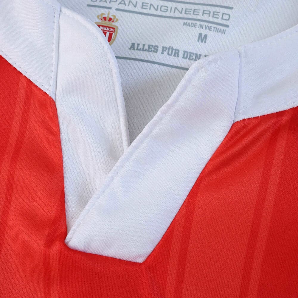 Close-up of the AS Monaco 2025/26 home player version jersey collar with red and white details.