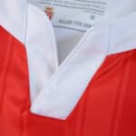 Close-up of the AS Monaco 2025/26 home player version jersey collar with red and white details.