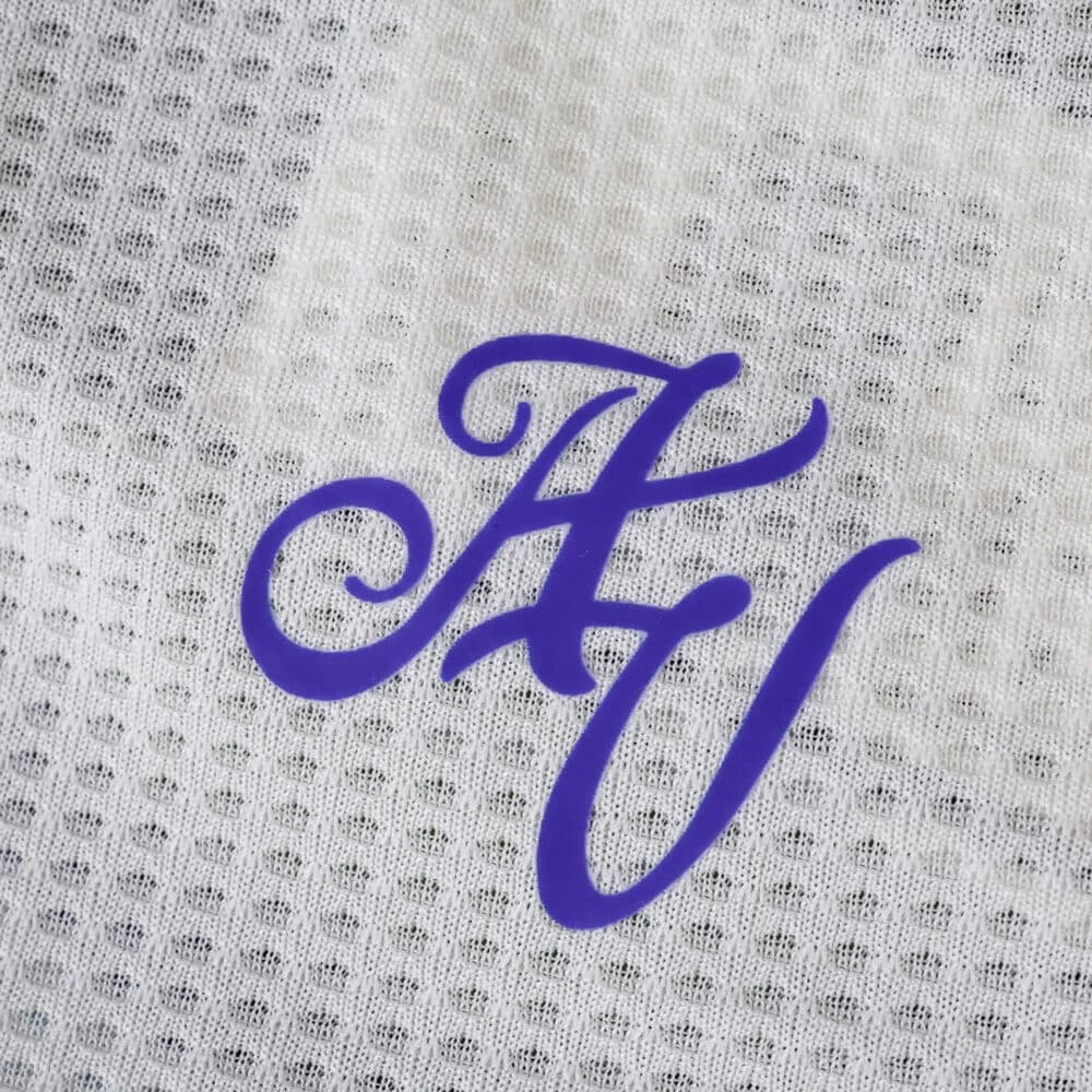 Close-up of the Aston Villa Third 2025/26 Player Version jersey with a purple "AV" monogram on white fabric.