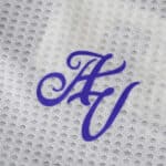 Close-up of the Aston Villa Third 2025/26 Player Version jersey with a purple "AV" monogram on white fabric.