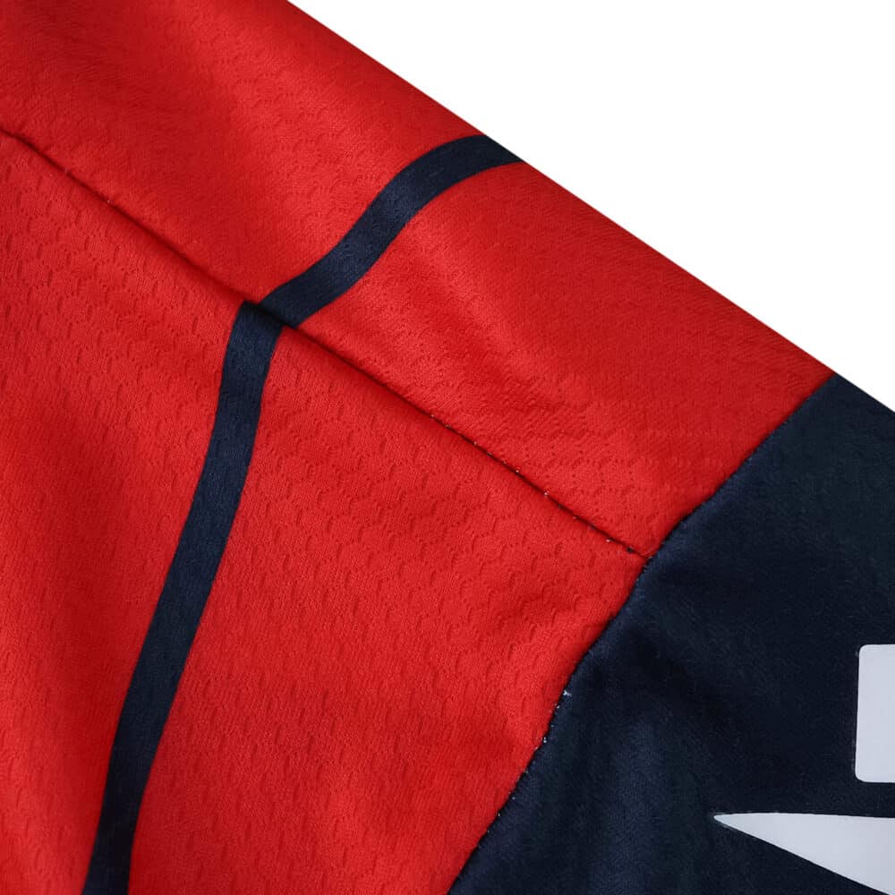 Close-up of the Bologna Home 2025/26 Fan Version jersey showing red and navy blue fabric details.