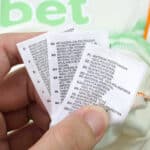 Close-up of Celtic Third 2025/26 Player Version shirt care tags with washing instructions in multiple languages.