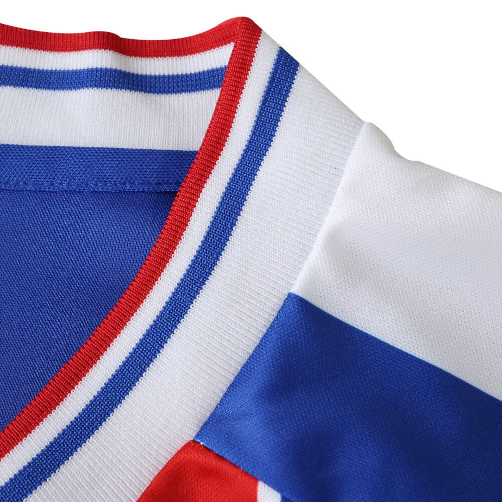 Close-up of the Crystal Palace Home 2025/26 Fan Version jersey collar with blue, red, and white stripes.