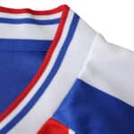 Close-up of the Crystal Palace Home 2025/26 Fan Version jersey collar with blue, red, and white stripes.