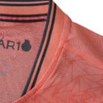 Close-up of FC Porto Away 2025/26 Player Version jersey collar with pink fabric and navy stripe details.