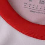 Close-up of the collar on the Granada Home 2025/26 Fan Version jersey, showing red trim and fabric details.