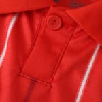 Close-up of the red Nottingham Forest 2025/26 Home Fan Version jersey collar and button detail.