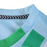 Close-up of Real Betis Away 2025/26 Fan Version jersey collar with green and light blue details.