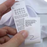 Close-up of care and manufacturer labels on the Valencia Home 2025/26 Fan Version jersey.